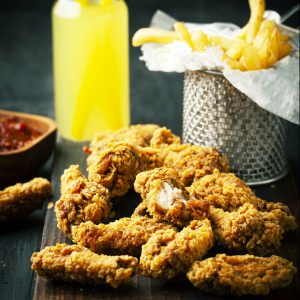 Fried chicken wings with ketchup, sauce and lemonade