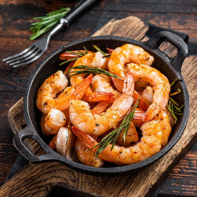 Shrimps in a pan with herbs and garlic.